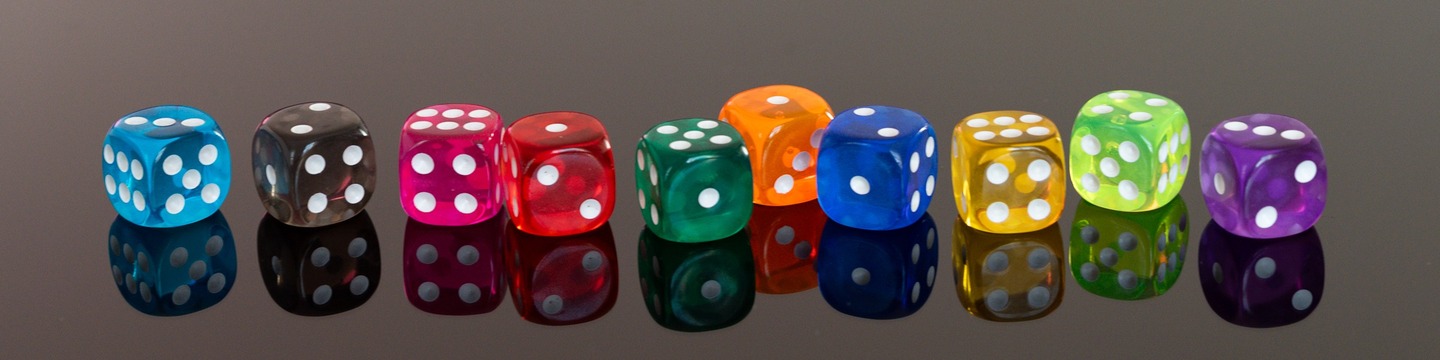 A row of 10 colourful dice on a reflective grey background