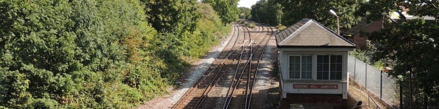 Photo showing railway tracks next to a small building showing Dudding Hill junction